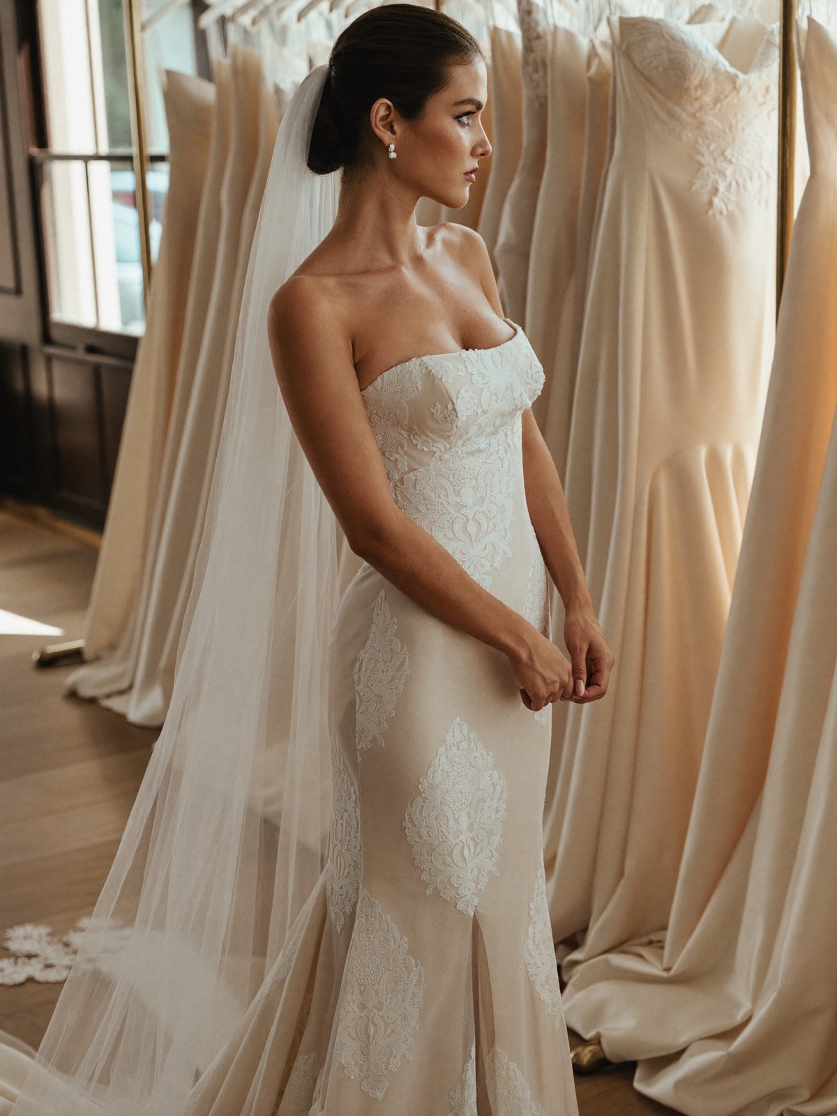 A bride in a lace gown at her appointment inside a bridal boutique
